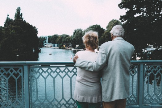 senior-couple-embracing-on-bridge